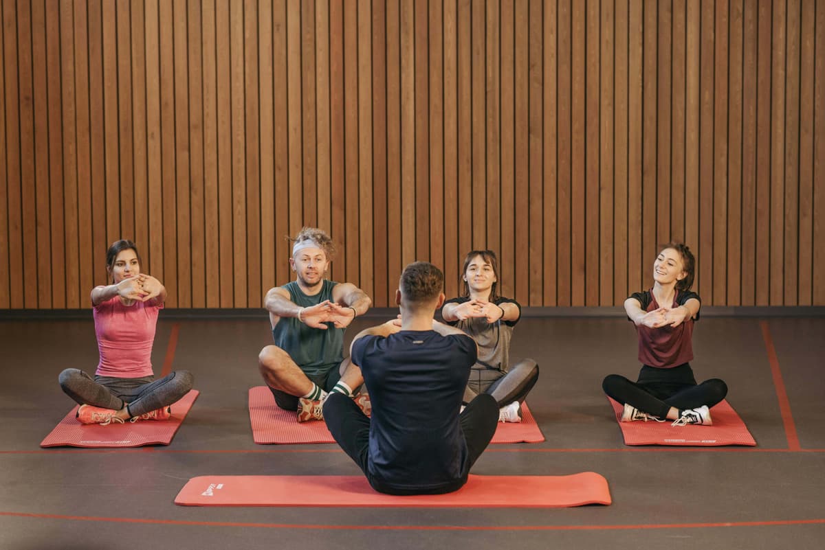 People Practicing Yoga Inside the Studio