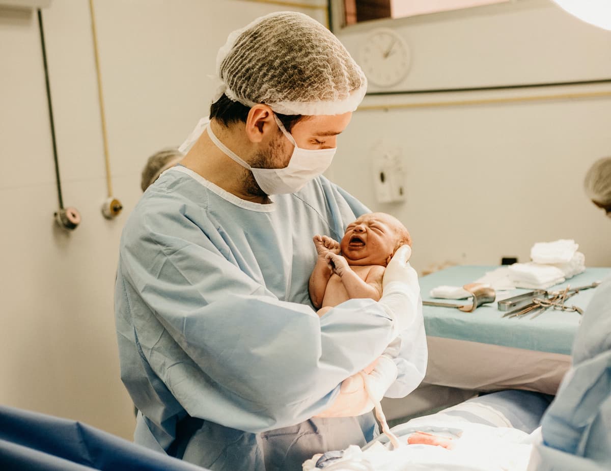 obgy holds a newborn baby obgy holds a newborn baby