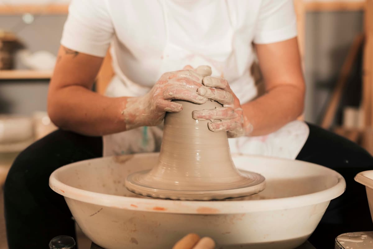hands-female-potter-creating-earthen-jar-pottery-wheel